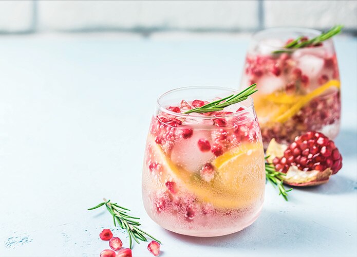 Cocktail with pomegranate, orange, rosemary