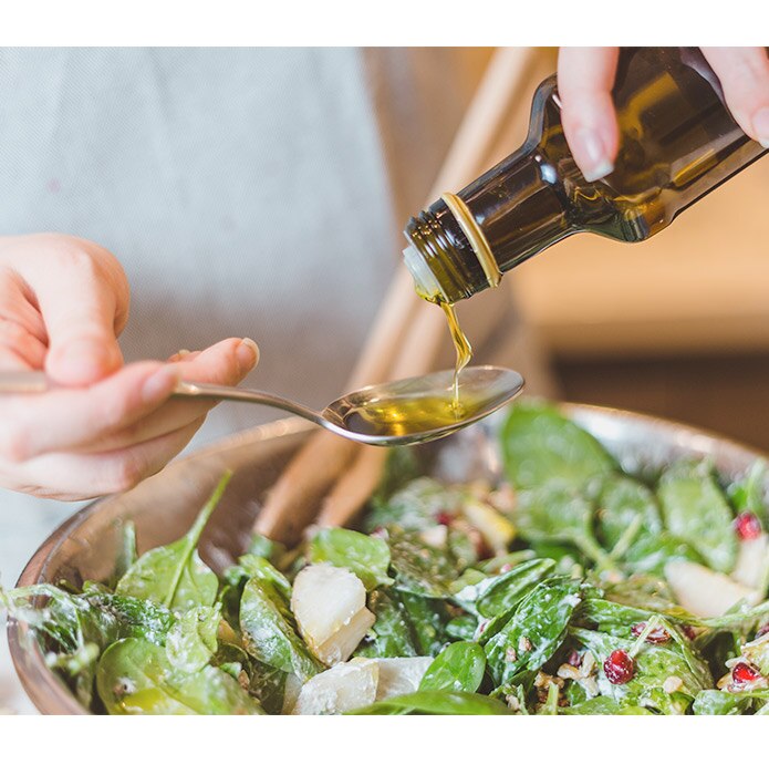 Pouring oil on salad