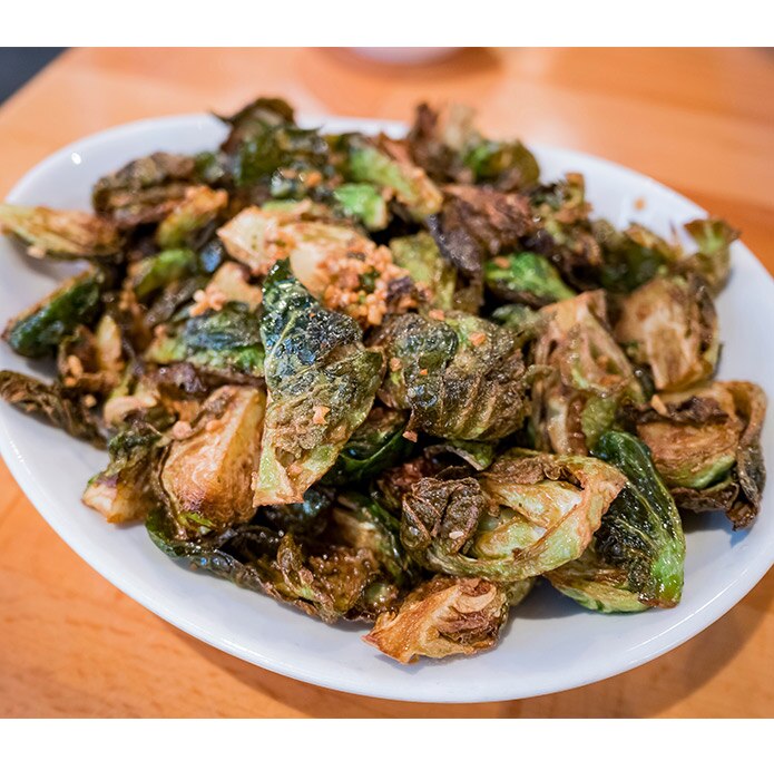 Deep fried brussels sprouts on a white plate
