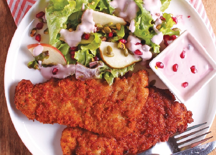 Air-fried pork schnitzel with pear & pomegranate salad