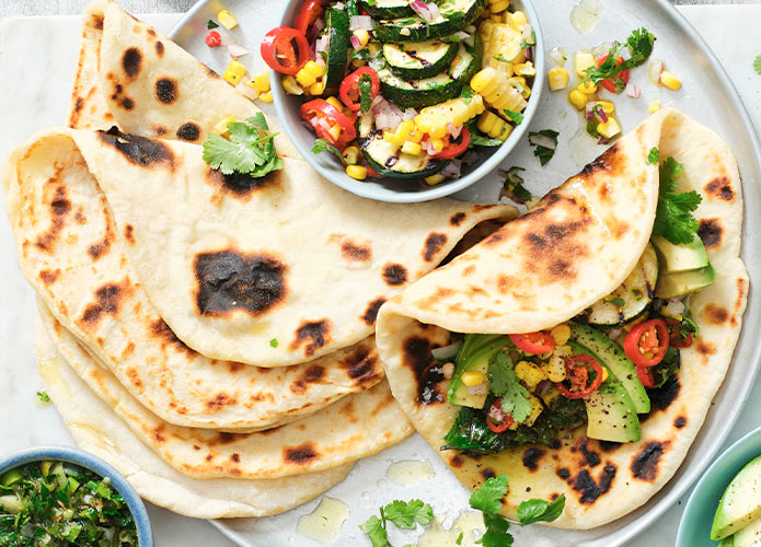 Potato flatbread with spring onion salsa, corn & zucchini salad, & avocado