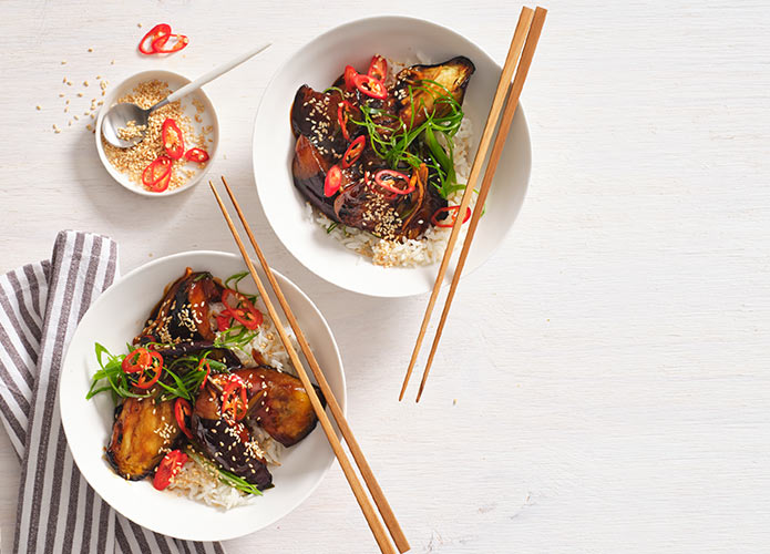 Spicy Chinese-style eggplant with rice, sesame seeds and spring onion