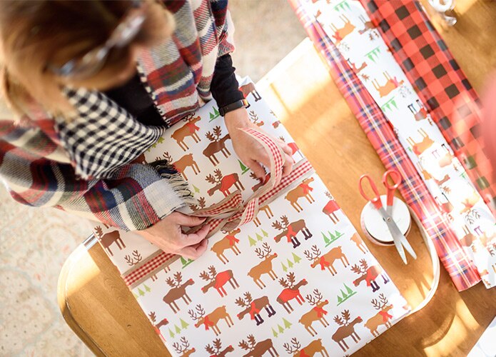 Top view of woman wrapping presents