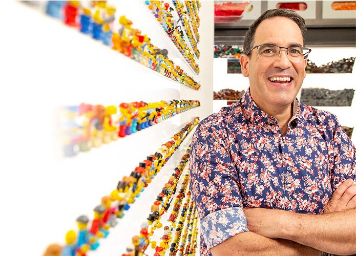 Ryan McNaught next to Lego wall