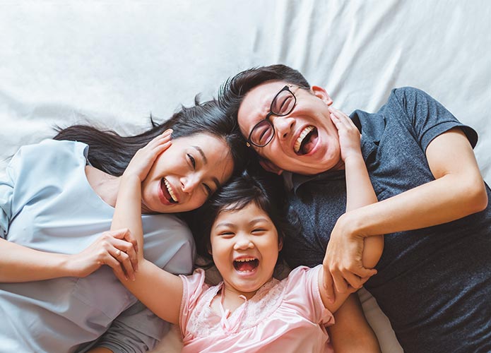 Mum, child and dad hugging