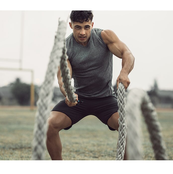 Man exercising with ropes