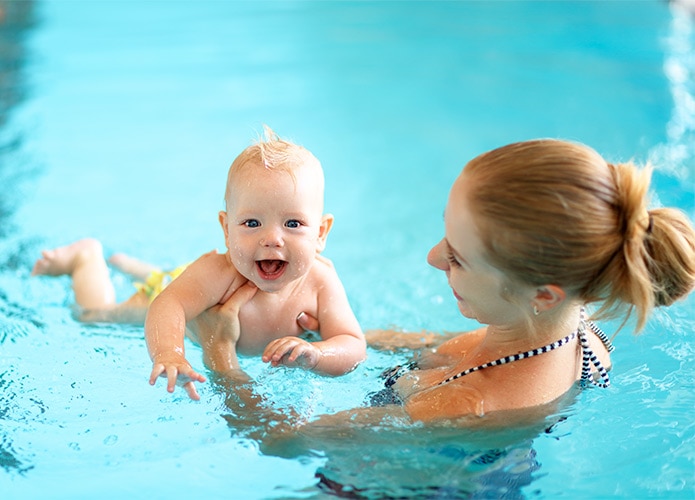 Parent teaching babay to swim