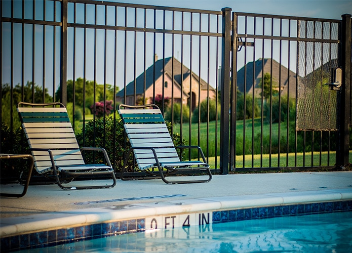 Deck chairs within fenced pool area