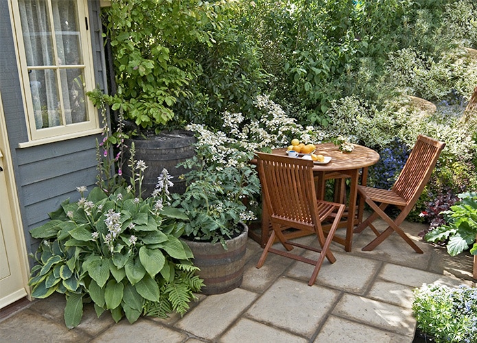 Small courtyard garden with table and chairs