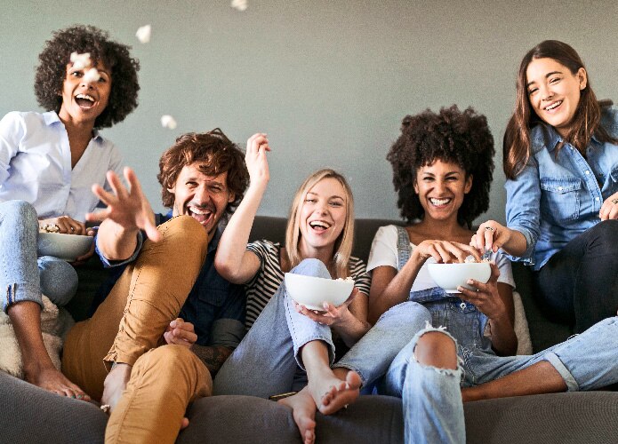 Friends throwing popcorn