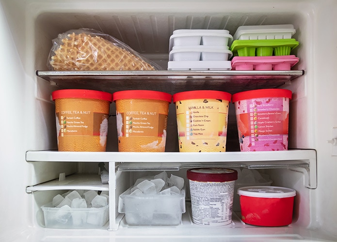 Freezer stocked with ice cream and ice