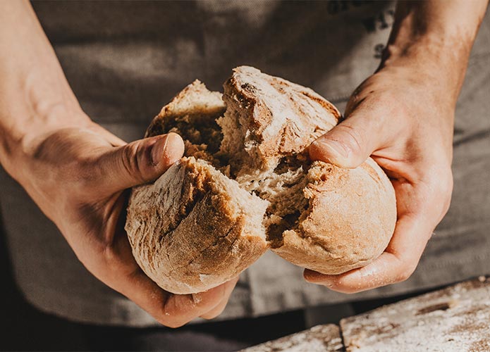 Man breaking rye bread