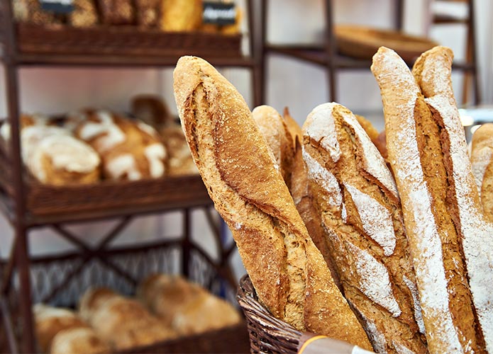 Baguettes in basket in shop