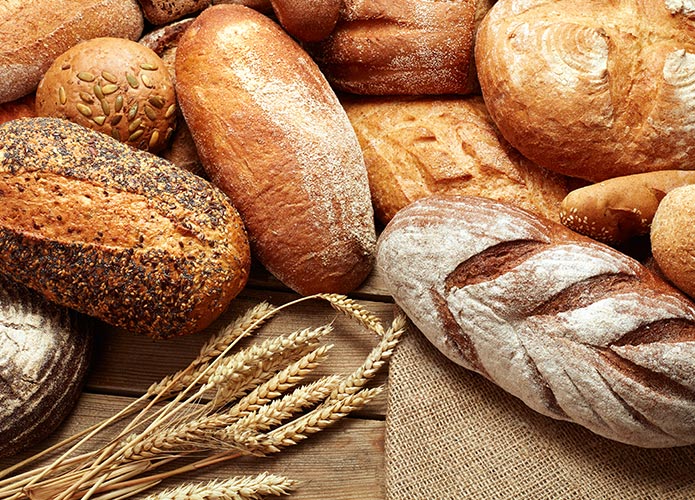 Artisan bread and wheat on table