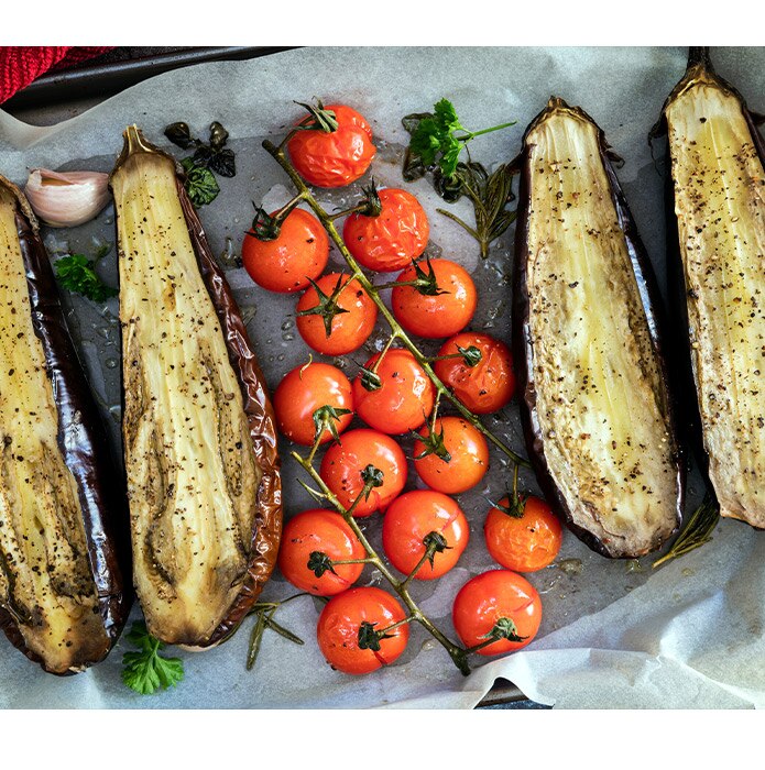 Cherry truss tomatoes roasted next to eggplant