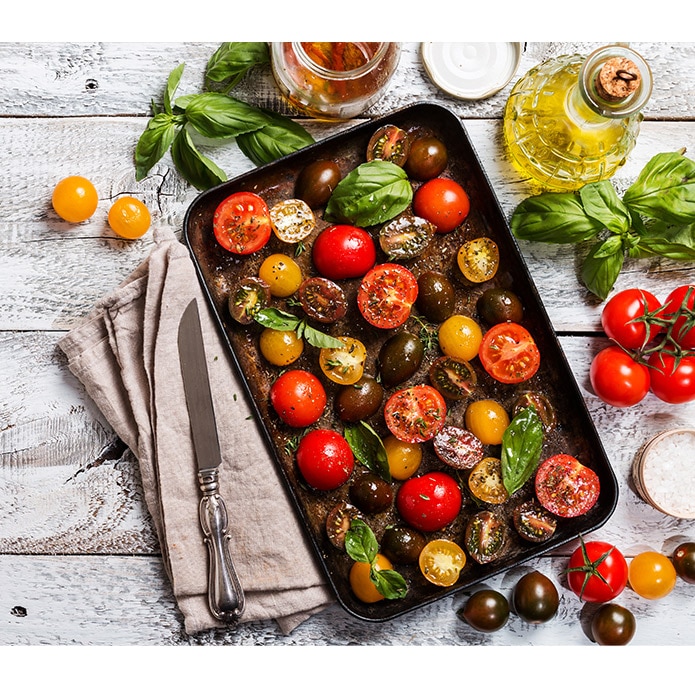 Multi-coloured tomatoes in roasting pan