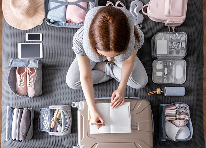 Woman planning luggage packing