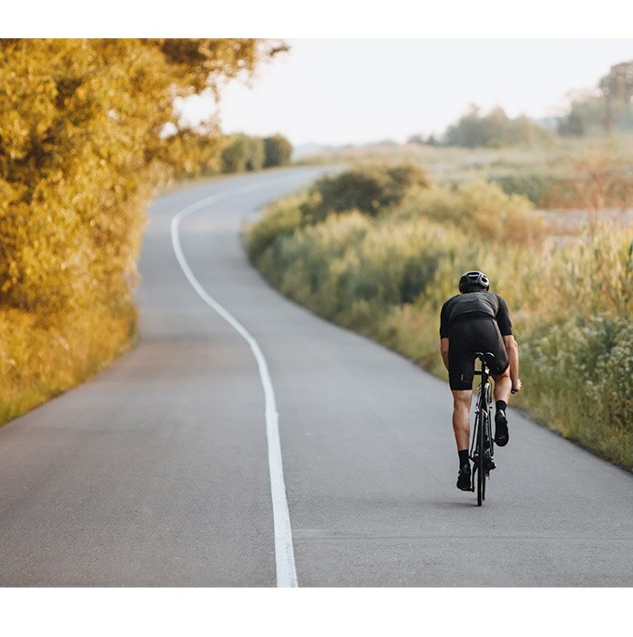 Man riding bike on country road