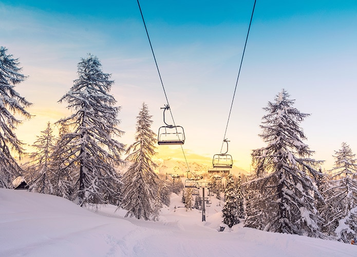 Ski lifts over snowy valley