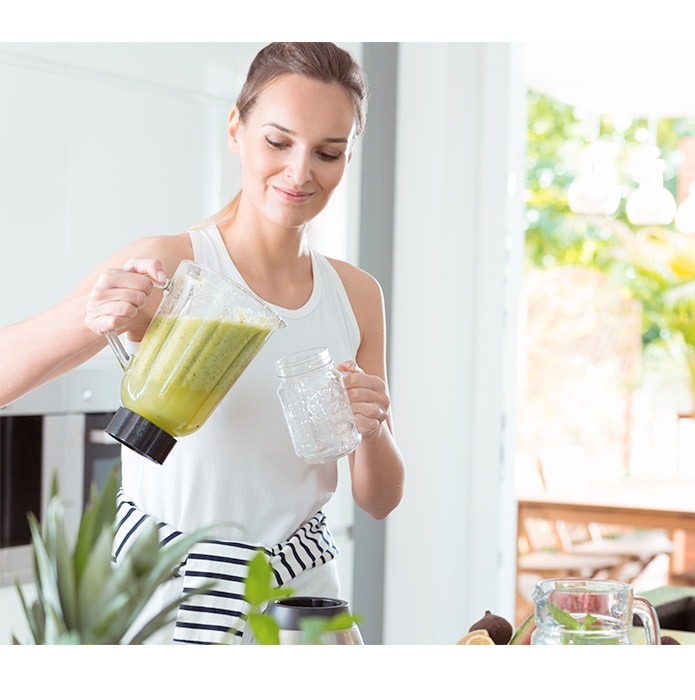 Woman pouring smoothie