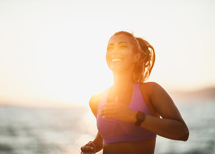 Woman running in the sunrise