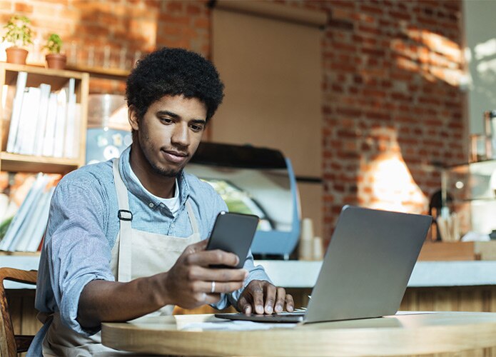 Man on laptop & phone