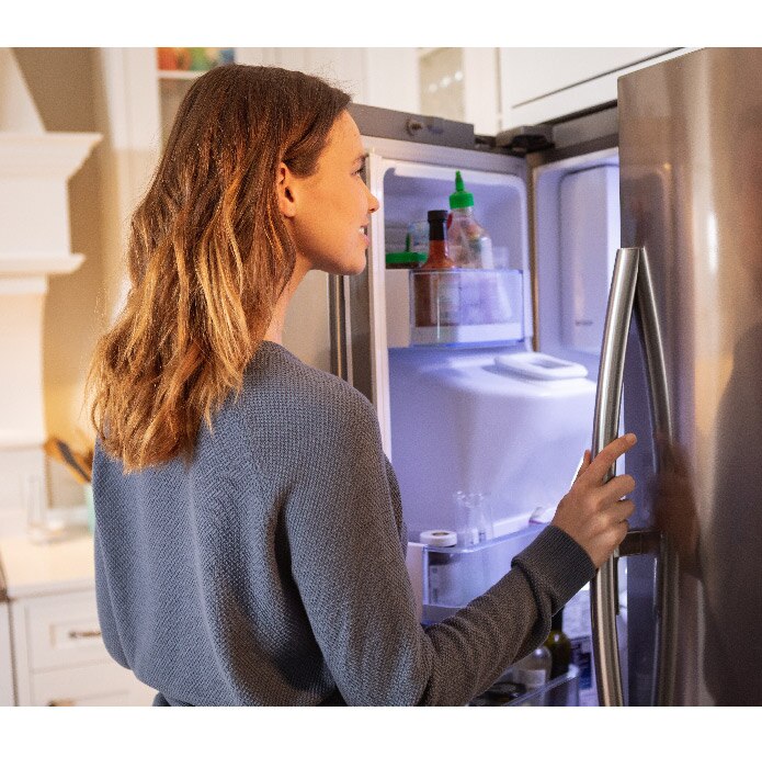 Woman looking into fridge