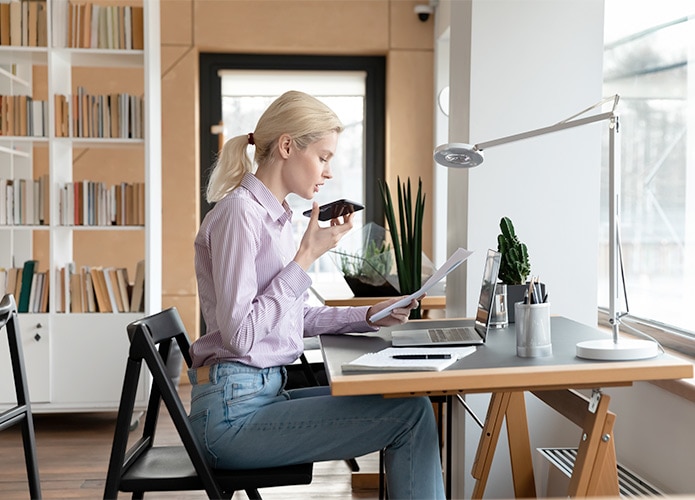 Woman speaking into phone at desk