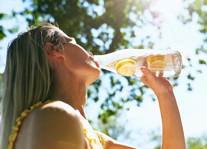 Woman drinking lemon water